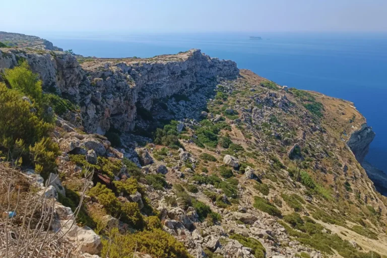 Malta’s coastline with clear waters, cliffs, and greenery.