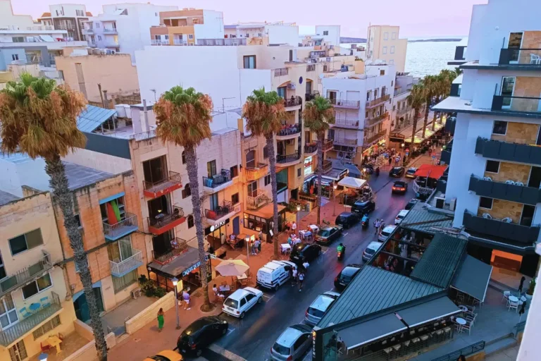 Typical Maltese street in St. Paul’s Bay, with limestone buildings and balconies.