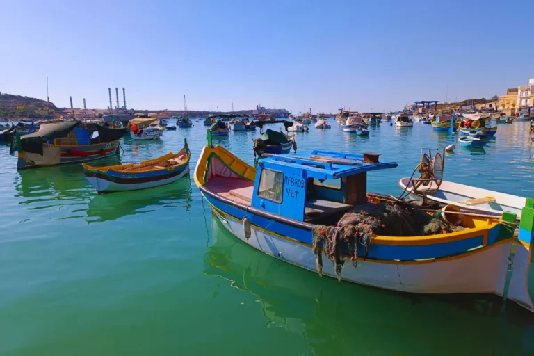 Colorful traditional fishing boats (luzzus) at Marsaxlokk Port, Malta.