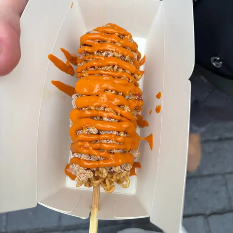 Delicious corndog from the Bunsik shop in Chinatown, featuring a crispy golden coating and savory filling